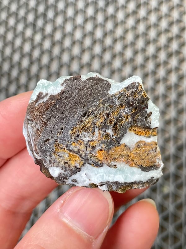 Pale mint-green botryoidal hemimorphite crust from Yunnan, China, detail of the matrix contact