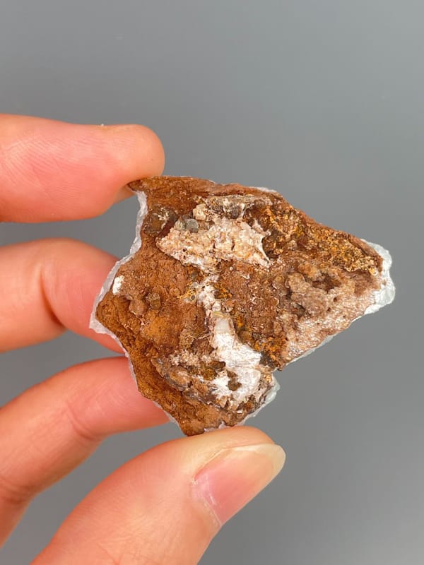 Pale mint-green botryoidal hemimorphite crust from Yunnan, China, detail of the matrix contact