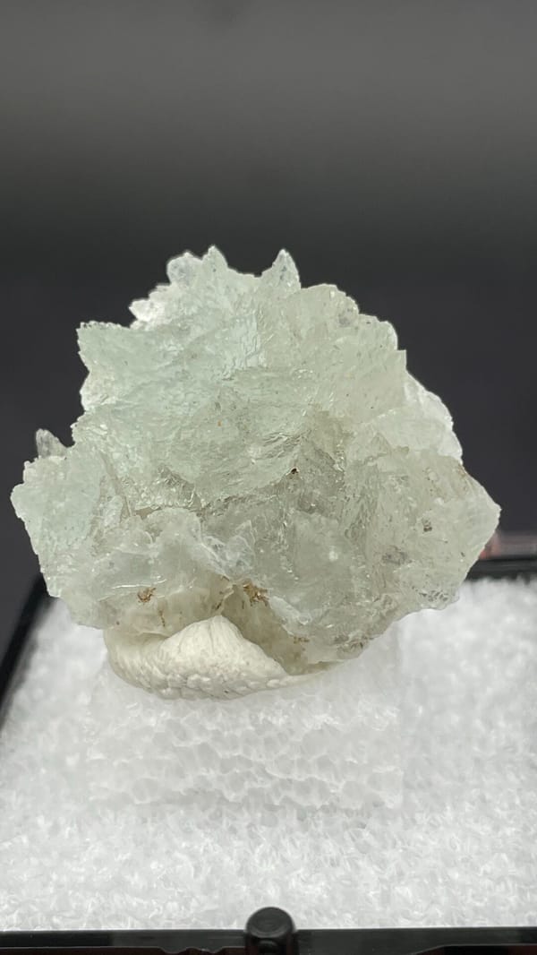 Pale mint-white bladed hemimorphite crust from Yunnan, China, in a display box