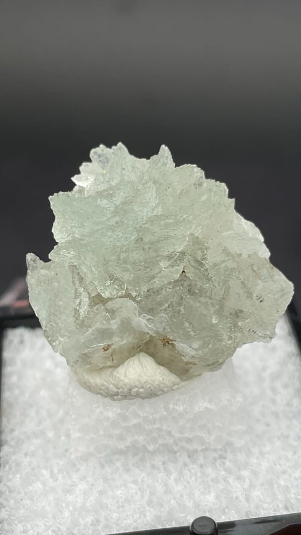 Pale mint-white bladed hemimorphite crust from Yunnan, China, in a display box, second angle