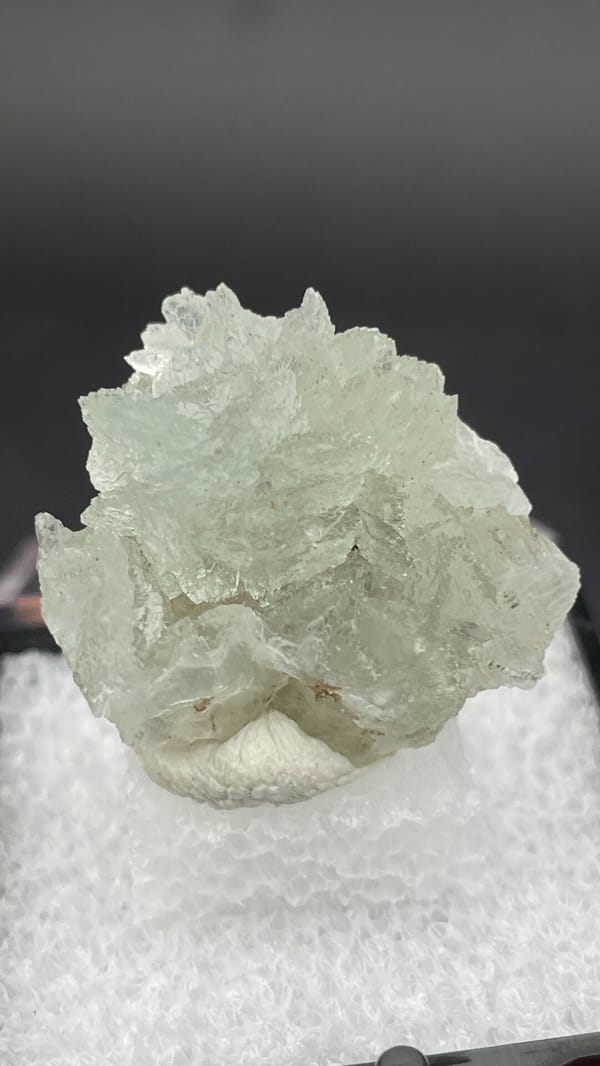 Pale mint-white bladed hemimorphite crust from Yunnan, China, in a display box, close-up of the crystal faces