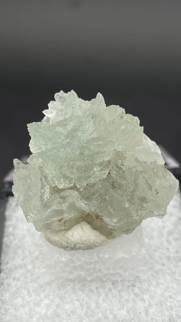 Pale mint-white bladed hemimorphite crust from Yunnan, China, in a display box, reverse side
