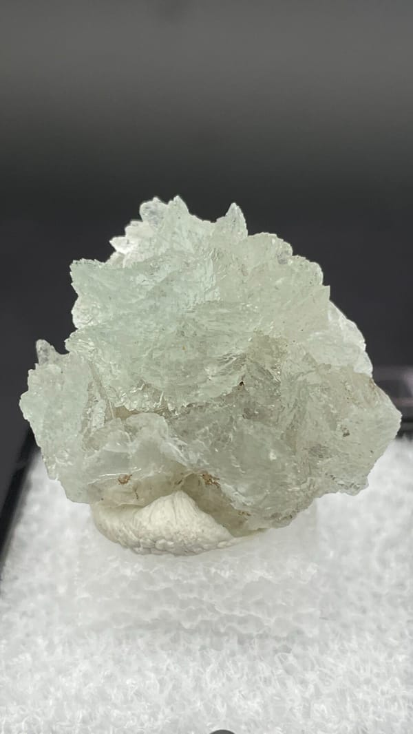 Pale mint-white bladed hemimorphite crust from Yunnan, China, in a display box, top view