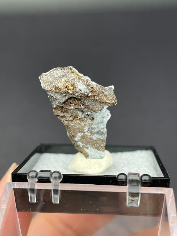 Pale blue-green botryoidal hemimorphite crust from Yunnan, China, in a display box, close-up of the crystal faces