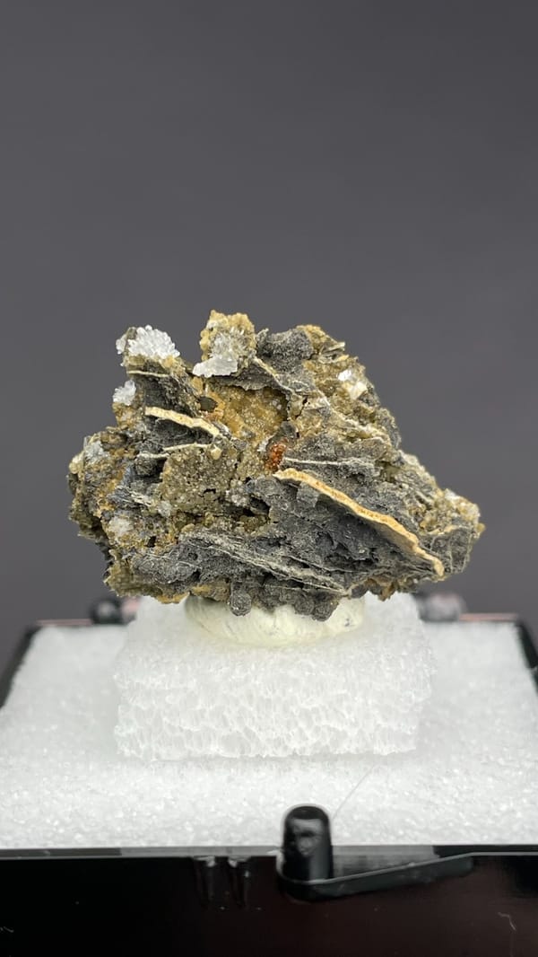 White bladed hemimorphite flowers on dark matrix from Guangxi, China, in a box