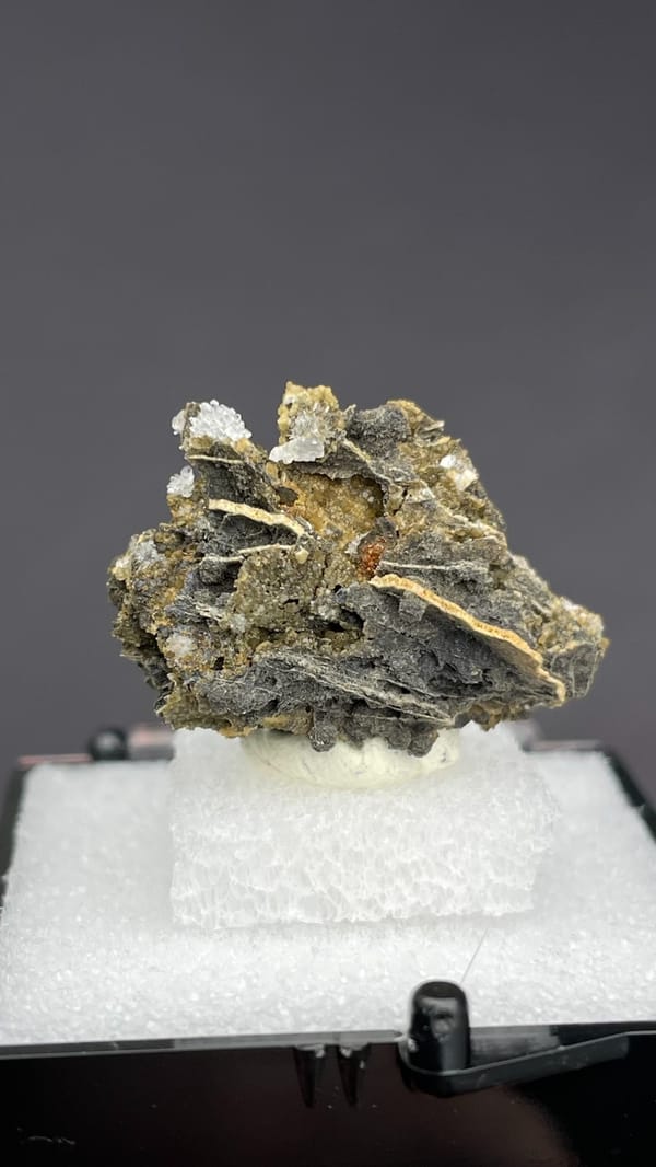 White bladed hemimorphite flowers on dark matrix from Guangxi, China, in a box, second angle