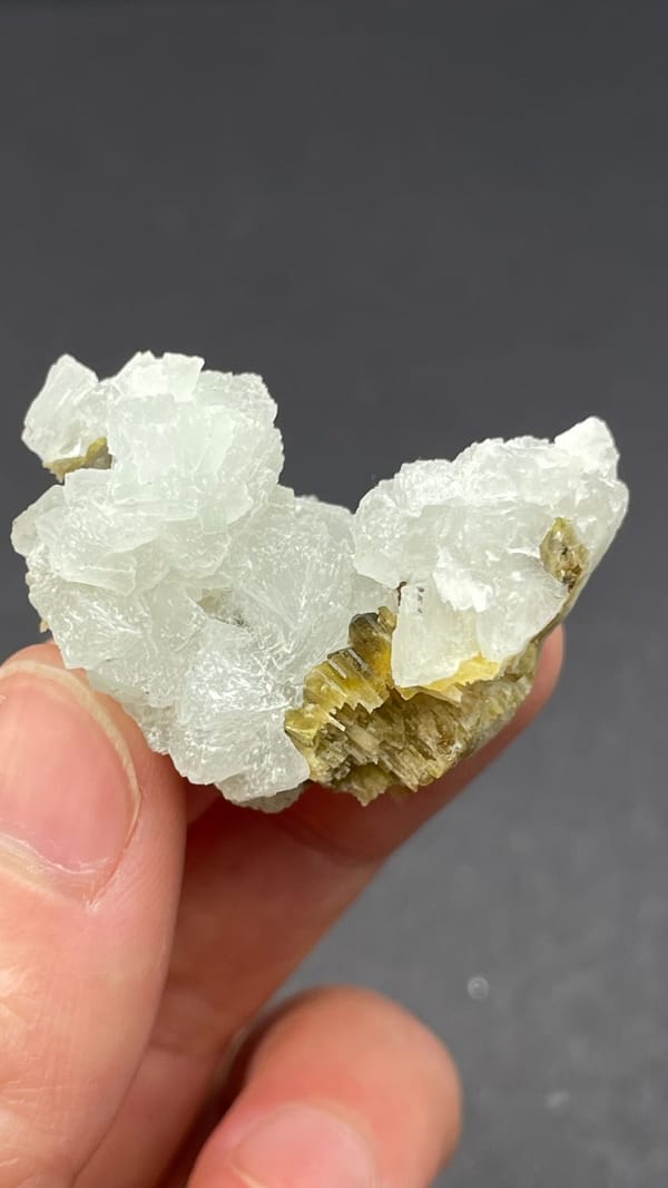 White botryoidal prehnite with yellow-green clinozoisite blades from Peru, second angle