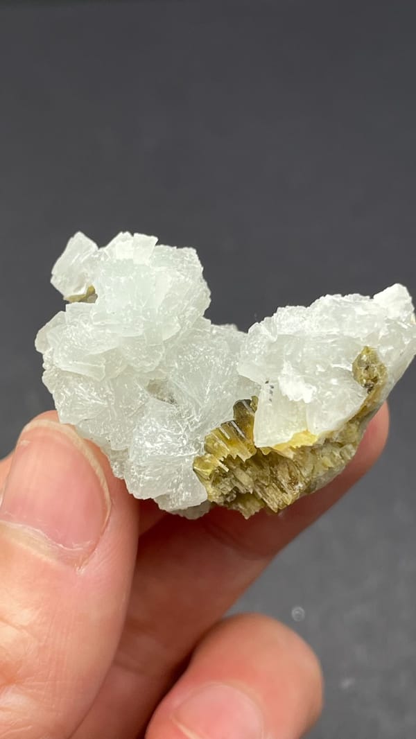 White botryoidal prehnite with yellow-green clinozoisite blades from Peru, close-up of the crystal faces