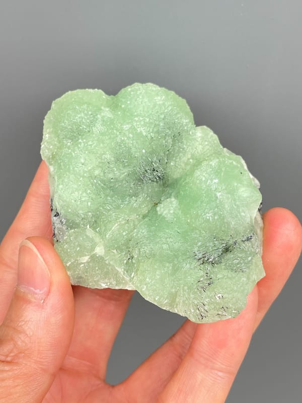 Apple-green botryoidal prehnite plate from Sichuan, China, close-up of the crystal faces