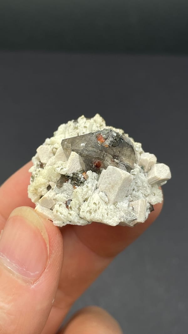 Smoky quartz crystal in cream feldspar from Yunxiao, Fujian, China, top view