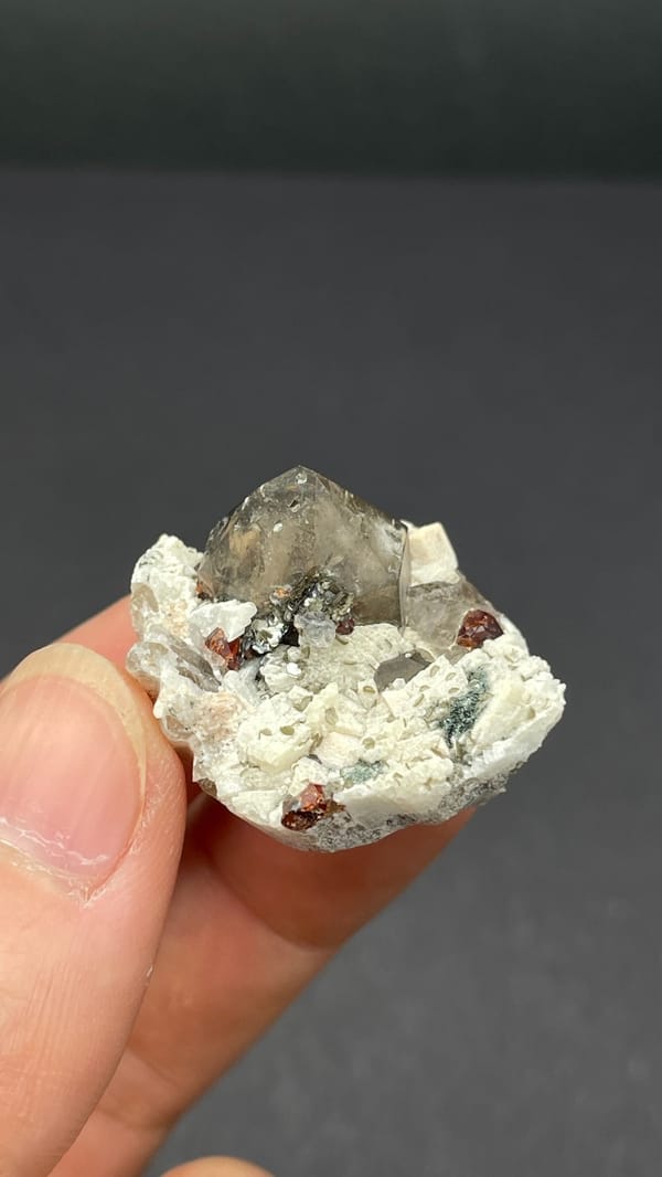 Smoky quartz and red garnets in white feldspar from Yunxiao, Fujian, China
