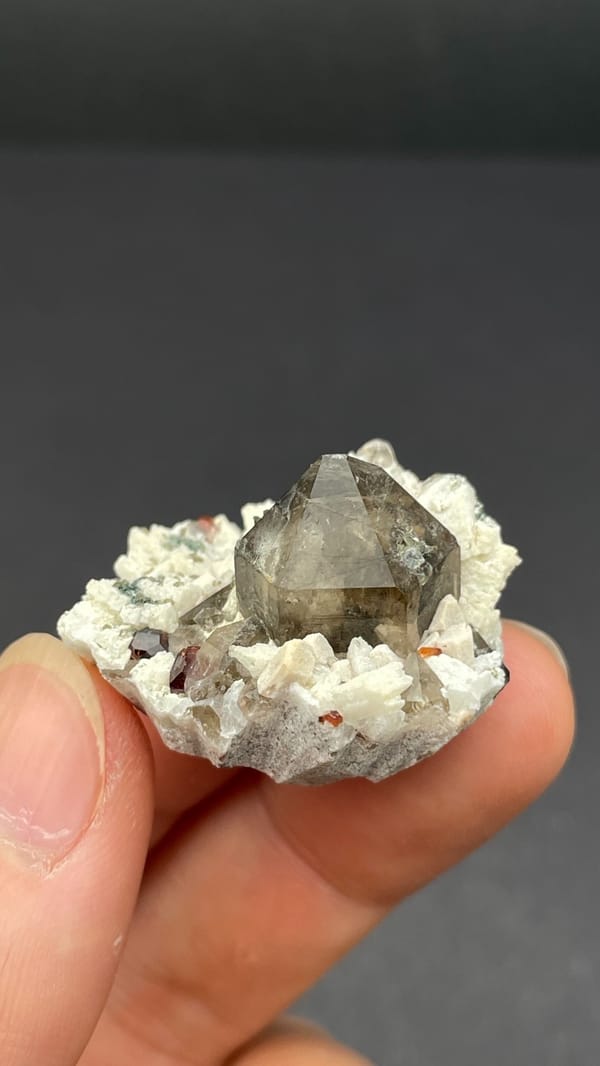 Smoky quartz and red garnets in white feldspar from Yunxiao, Fujian, China, reverse side