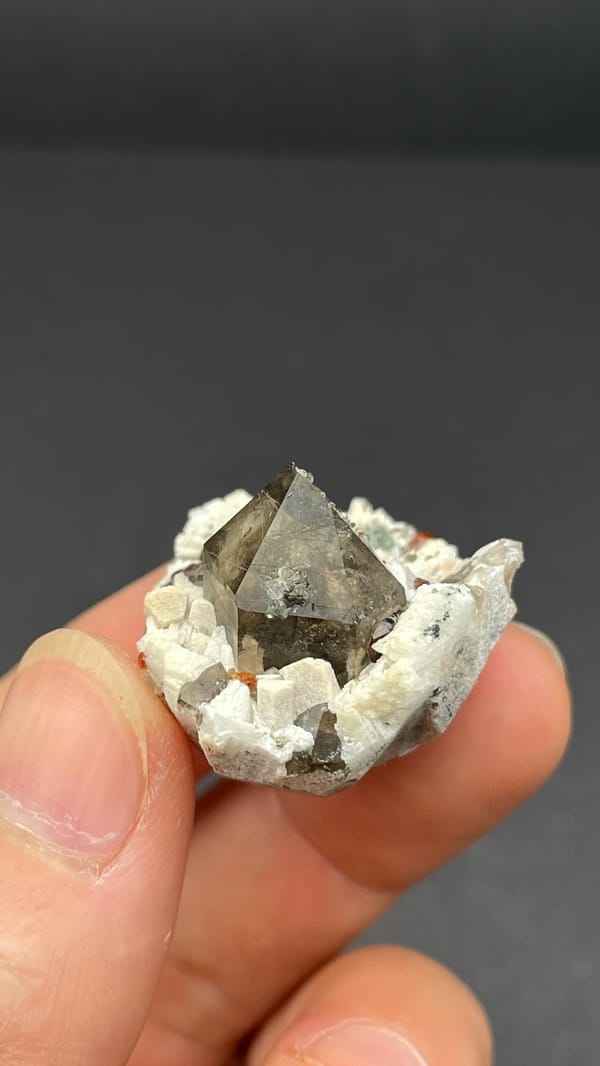 Smoky quartz and red garnets in white feldspar from Yunxiao, Fujian, China, top view