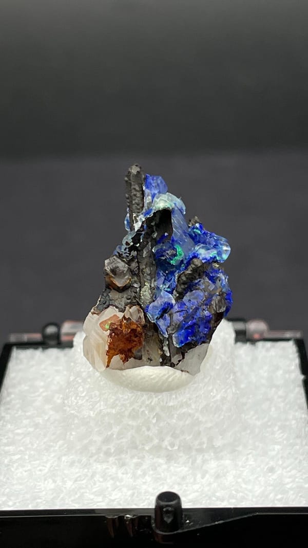 Electric blue azurite with green malachite on limonite from Morocco, in a box, detail of the matrix contact