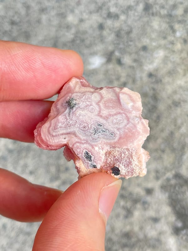 Bright pink botryoidal rhodochrosite from Argentina, detail of the matrix contact