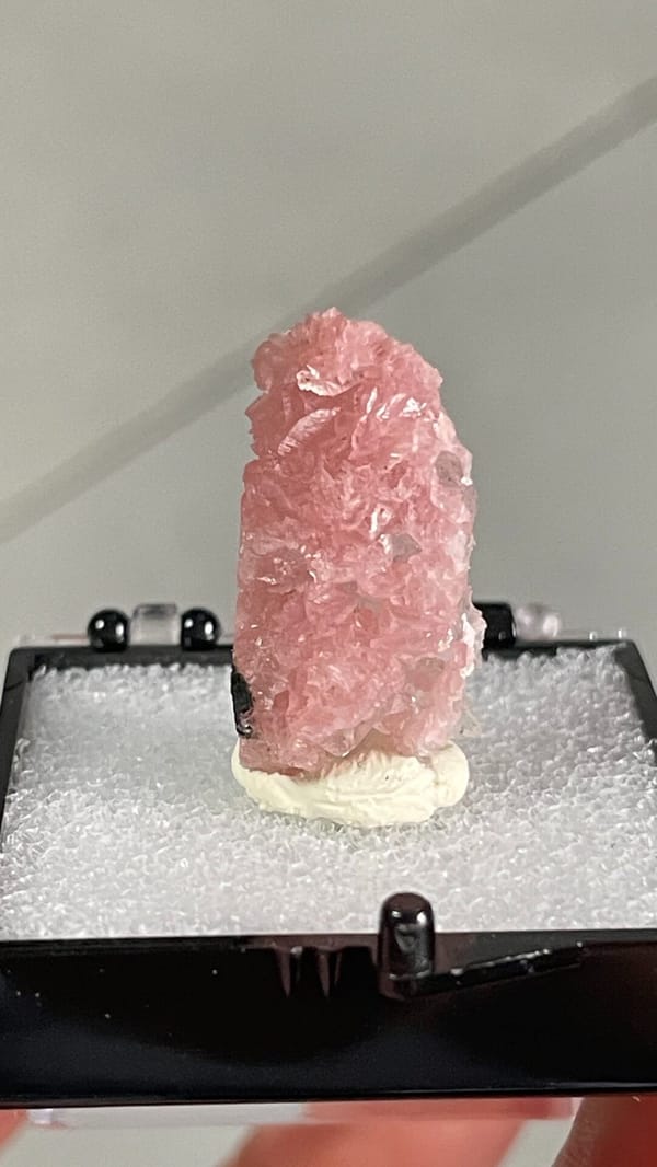 Rose-pink rhodochrosite crust from Wuzhou, Guangxi, China, in a display box