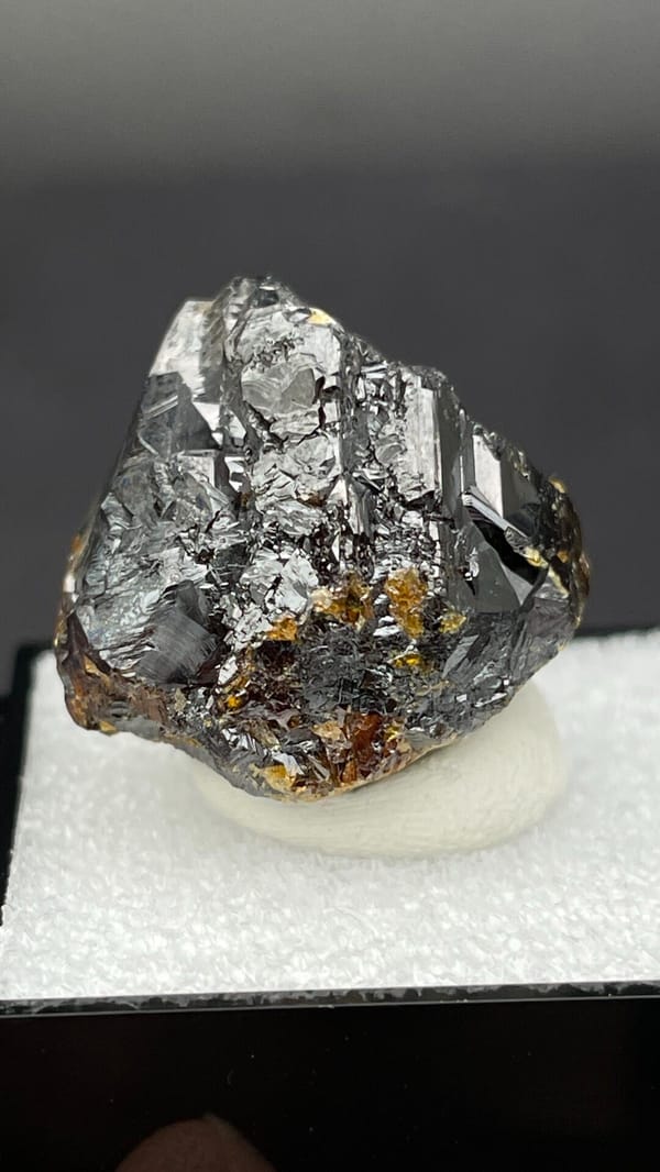 Dark brown Tennessee sphalerite crystal group from the USA, in a display box, top view