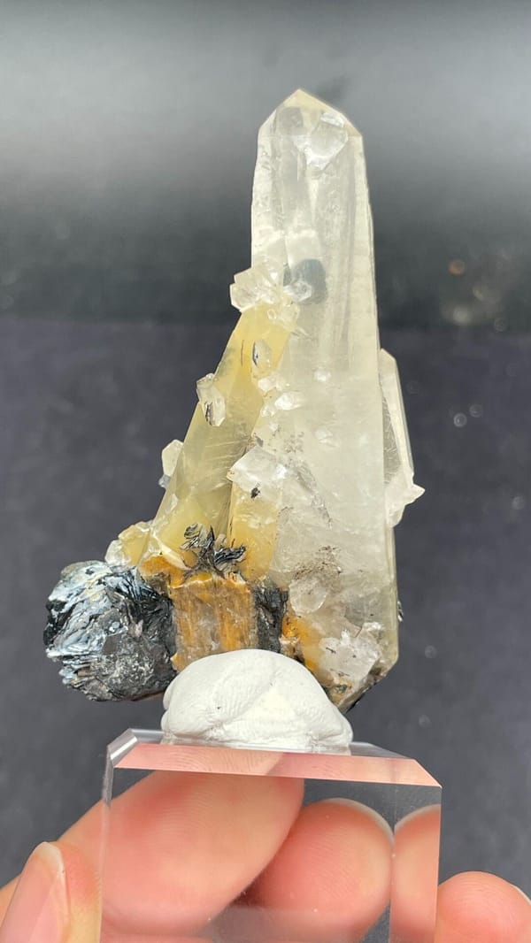 Pale quartz spire rising from black specular hematite, Guangdong, China, reverse side