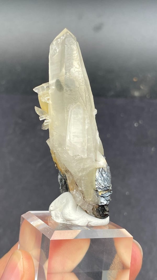 Pale quartz spire rising from black specular hematite, Guangdong, China, top view