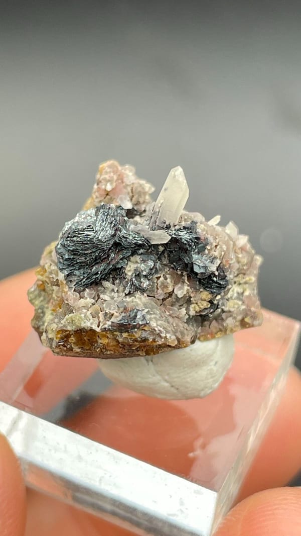 Dark metallic specular hematite rosette on matrix, Inner Mongolia, China, close-up of the crystal faces