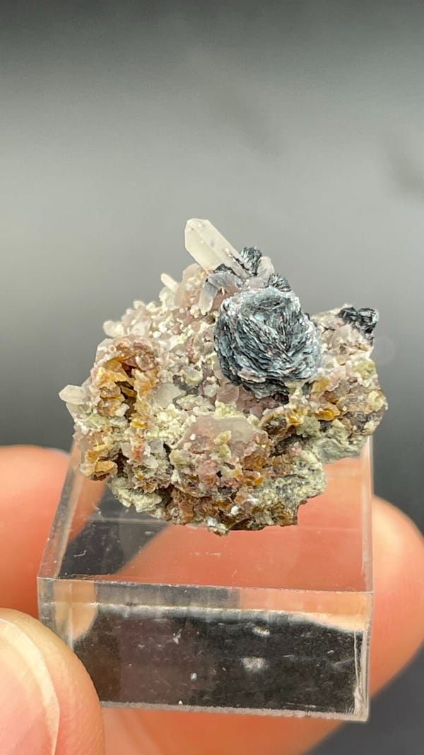 Dark metallic specular hematite rosette on matrix, Inner Mongolia, China, detail of the matrix contact