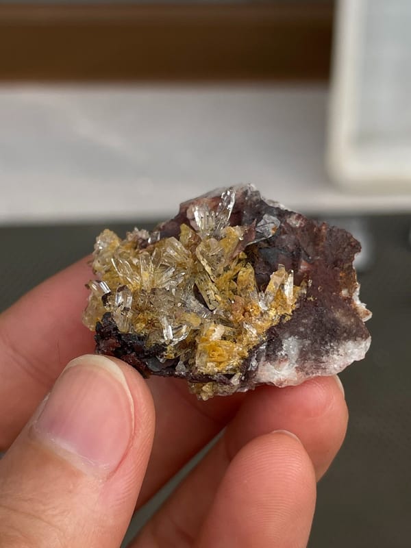Amber-gold creedite crystals on brown matrix from Guizhou, China, top view
