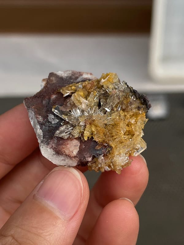Amber-gold creedite crystals on brown matrix from Guizhou, China, detail of the matrix contact