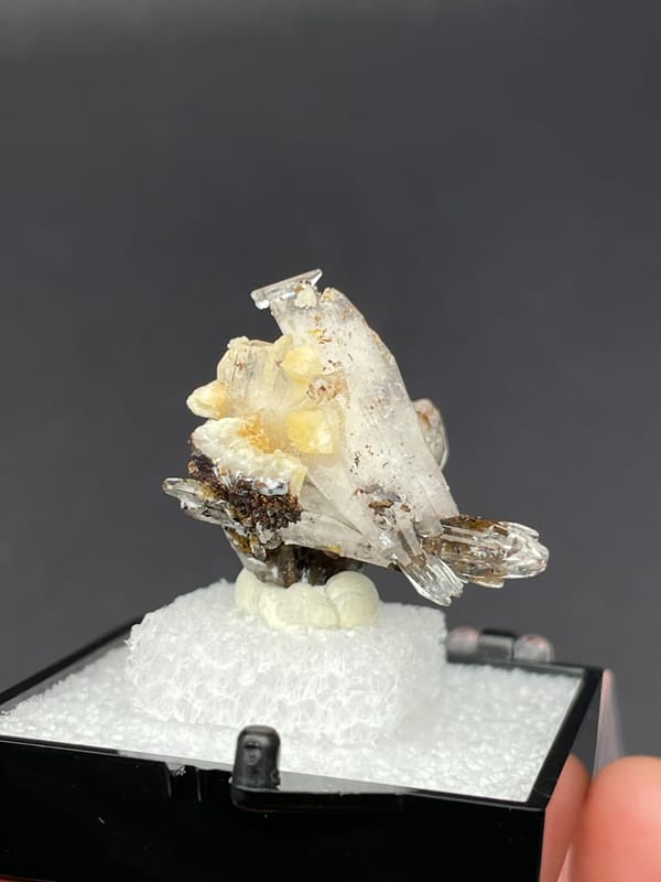 Colourless bladed creedite crystals with dark inclusions from Guizhou, China, second angle