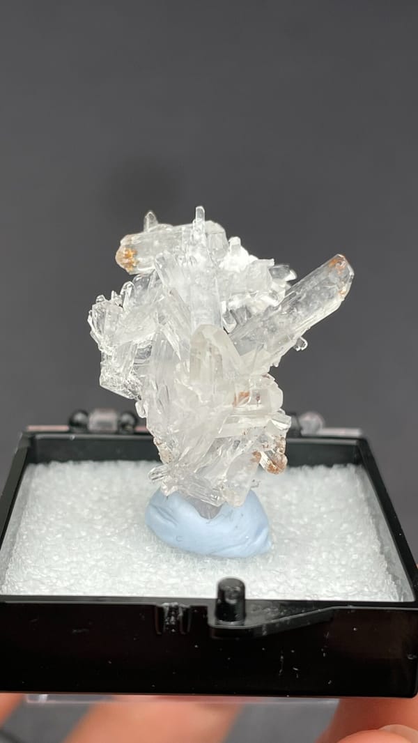 Colourless glassy creedite crystal spray from Guizhou, China, in a display box