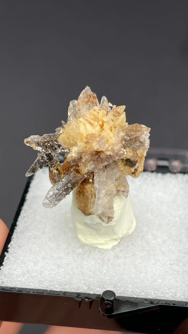 Colourless creedite and gypsum crystals radiating around a rock core, Guizhou, China