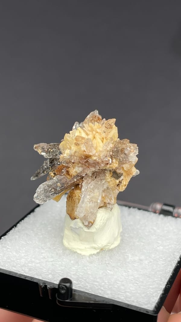 Colourless creedite and gypsum crystals radiating around a rock core, Guizhou, China, detail of the matrix contact