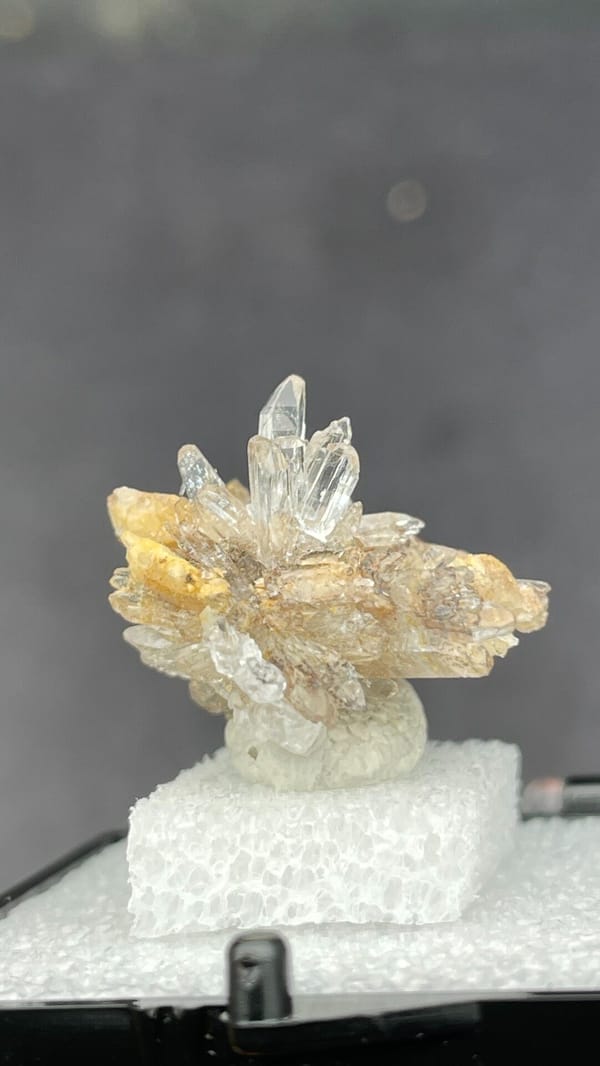 Colourless creedite and gypsum crystal flower from Guizhou, China, in a box, detail of the matrix contact