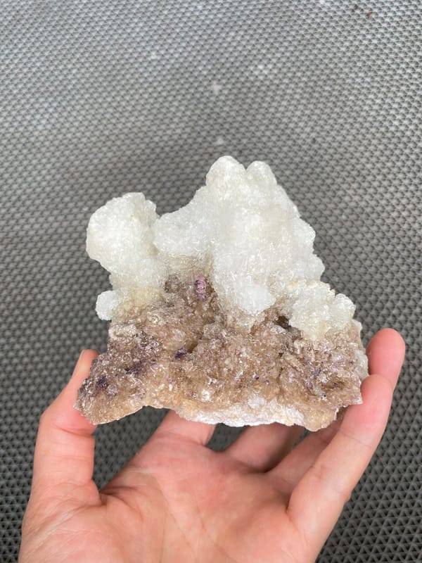 Large white creedite crystal crust on pale base from Guizhou, China, close-up of the crystal faces