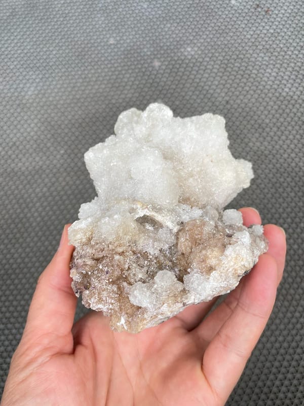 Large white creedite crystal crust on pale base from Guizhou, China, reverse side