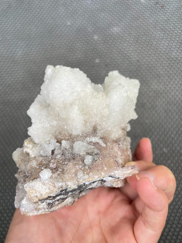 Large white creedite crystal crust on pale base from Guizhou, China, top view