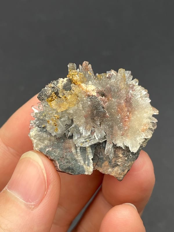White creedite needle sprays on a grey-brown rock from Guizhou, China, top view