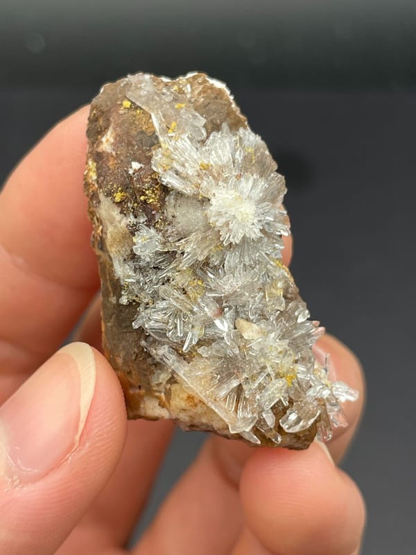 White creedite needle rosettes on brown rock from Guizhou, China
