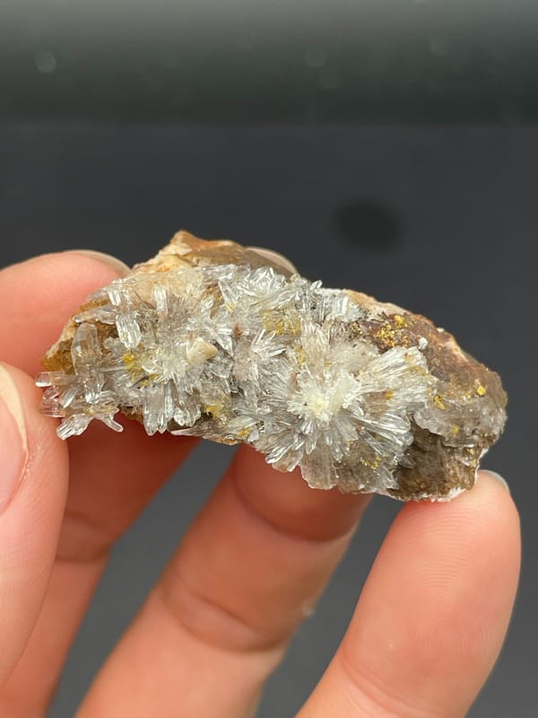 White creedite needle rosettes on brown rock from Guizhou, China, reverse side