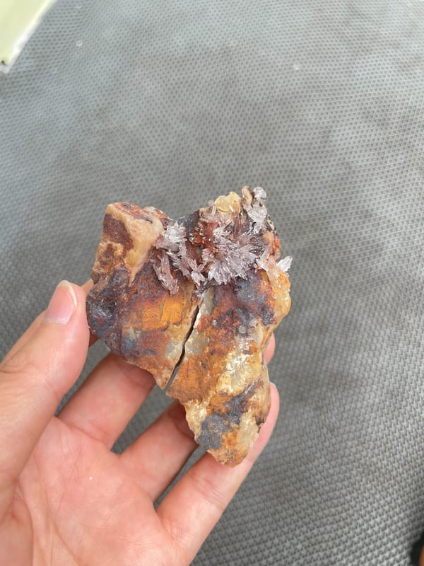 Pale creedite crystal crust on ochre-brown rock from Guizhou, China