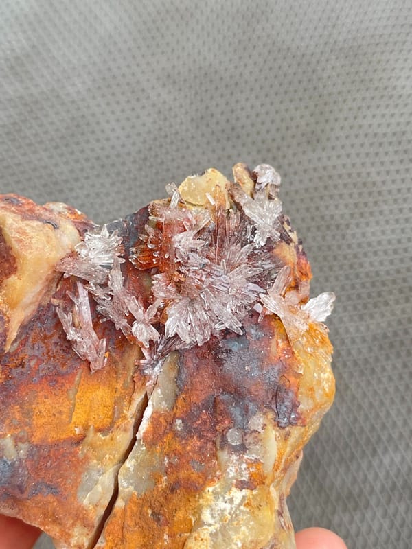 Pale creedite crystal crust on ochre-brown rock from Guizhou, China, second angle