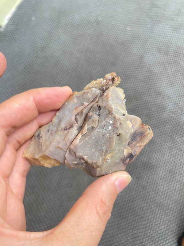 Pale creedite crystal crust on ochre-brown rock from Guizhou, China, reverse side