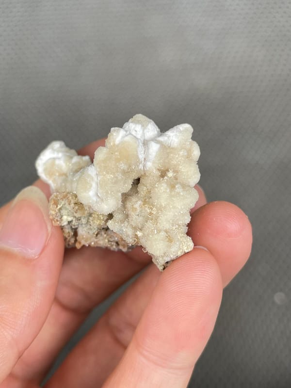 Cream popcorn-textured creedite crust from Guizhou, China, close-up of the crystal faces