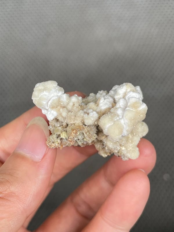 Cream popcorn-textured creedite crust from Guizhou, China, reverse side
