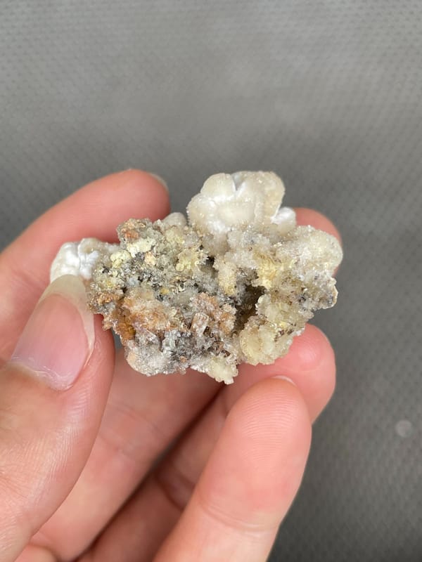 Cream popcorn-textured creedite crust from Guizhou, China, top view
