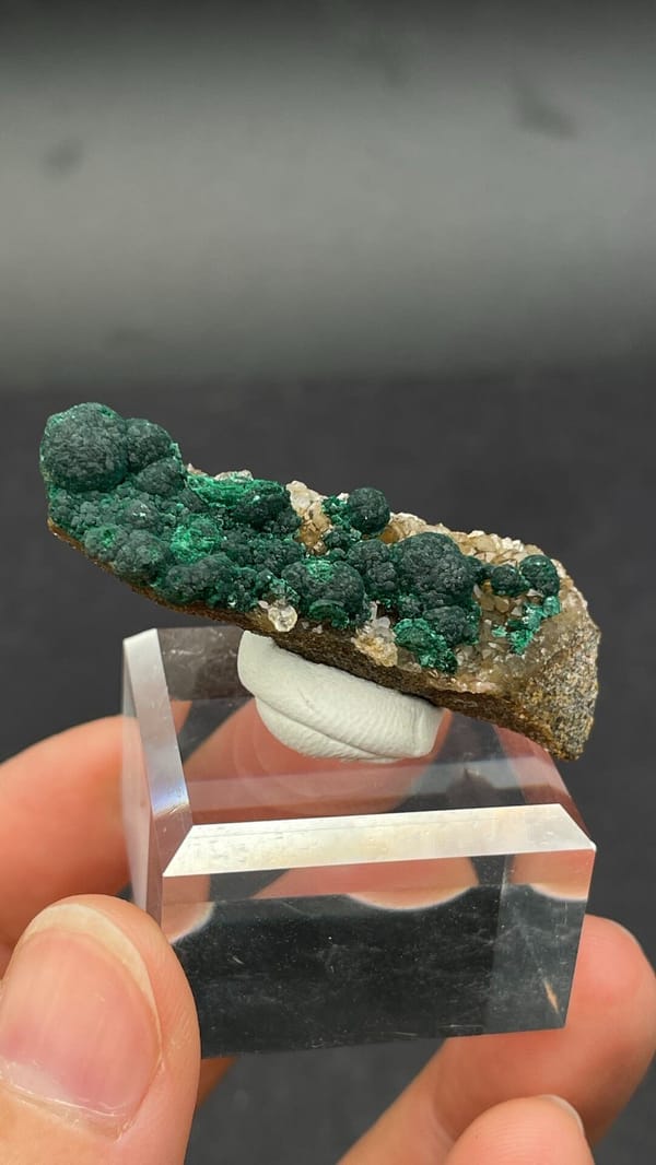 Dark green botryoidal malachite balls on a thin rock blade from DR Congo, second angle