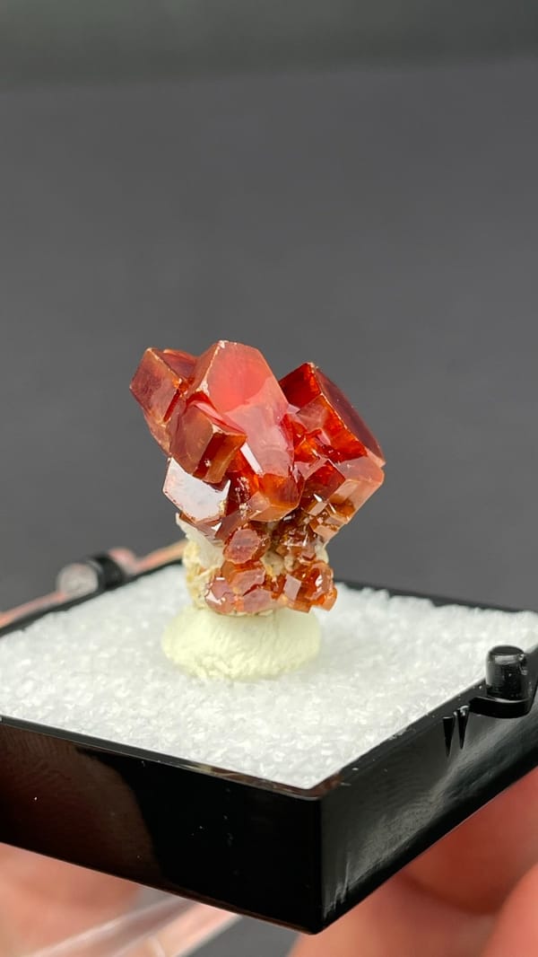 Deep red vanadinite crystal cluster from Morocco, in a display box, second angle