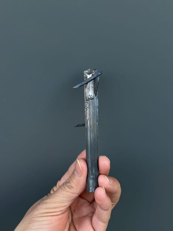 Long silver-grey striated stibnite blade from Yunnan, China, reverse side