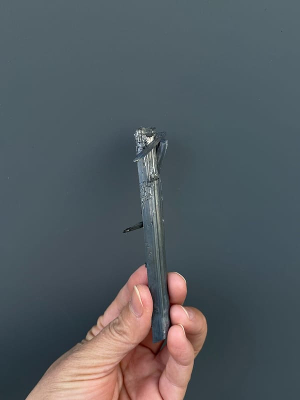 Long silver-grey striated stibnite blade from Yunnan, China, top view