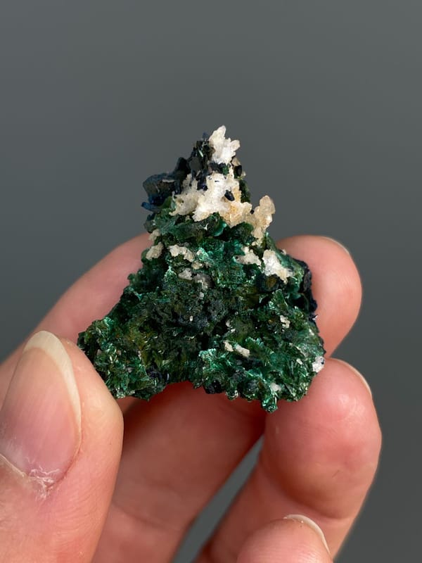 Deep green malachite with white crystals on top from Anhui, China