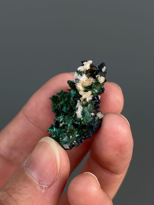 Deep green malachite with white crystals on top from Anhui, China, reverse side